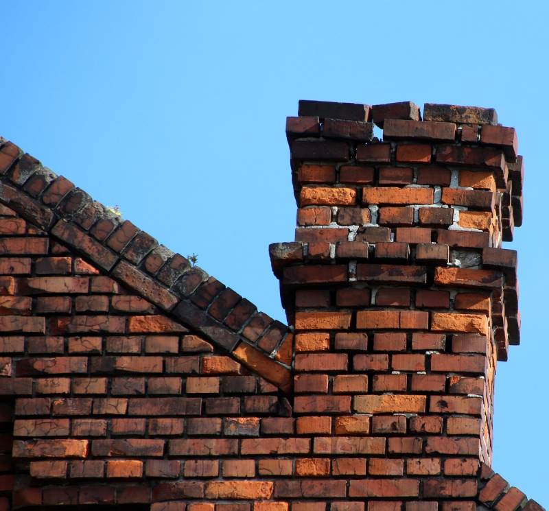 Blog Article - Damaged chimney on an Gibraltar home showing cracks and missing mortar